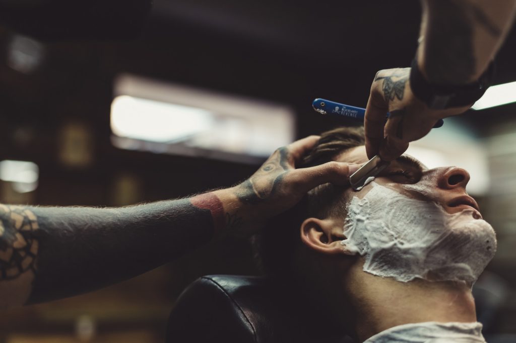 Barber shaving client